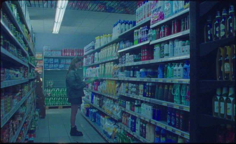 Woman browsing in a grocery store looks up towards the ceiling