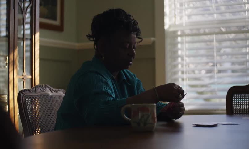 Woman playing cards inside a house