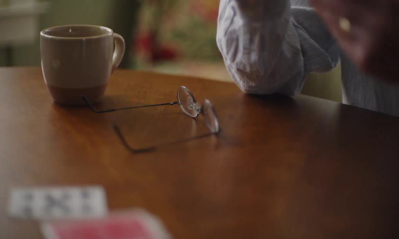 A woman is playing cards at the table