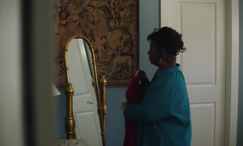 A footage of a woman looking at the mirror