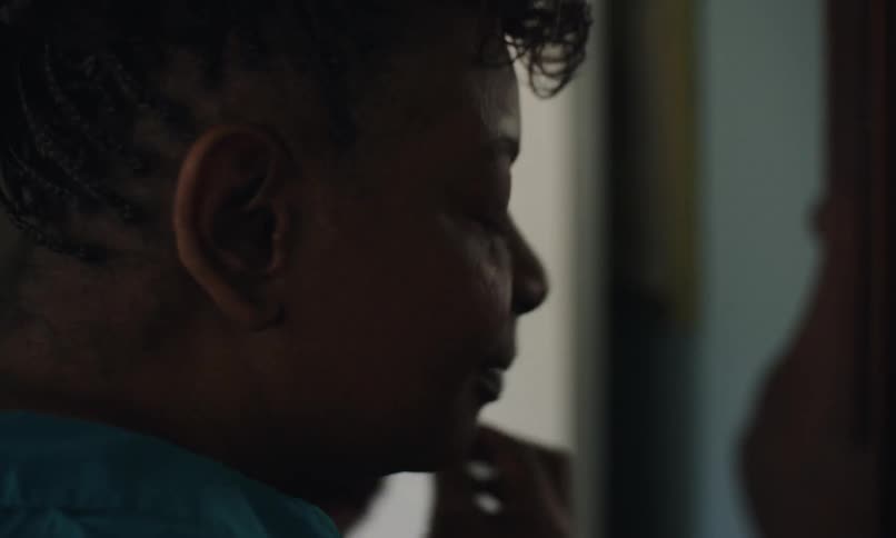 A woman puts on earrings