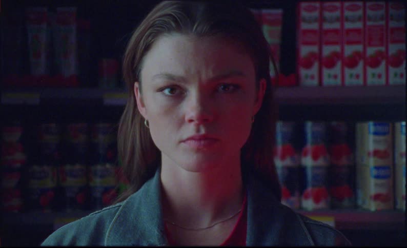 Portrait of a woman with a serious expression inside a supermarket