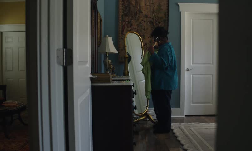 A woman is trying clothes in front of the mirror