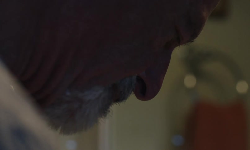 A man washes his razor in the sink