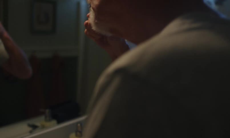Man putting toothpaste in toothbrush and brushing his teeth