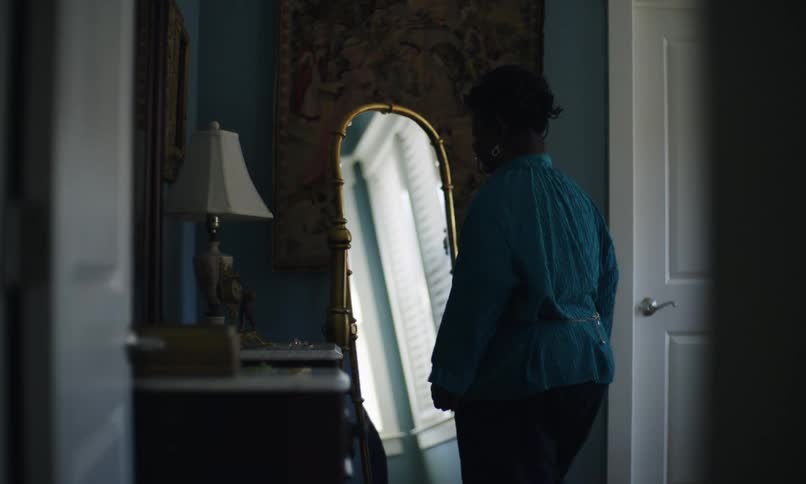 A footage of a person standing in front of a mirror