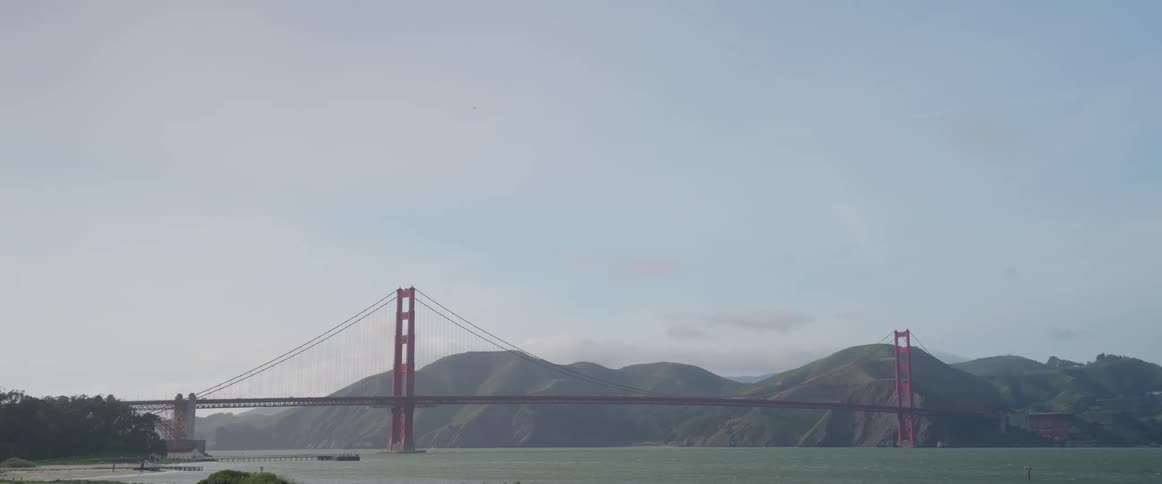 Landscape with a large bridge and mountains in the background