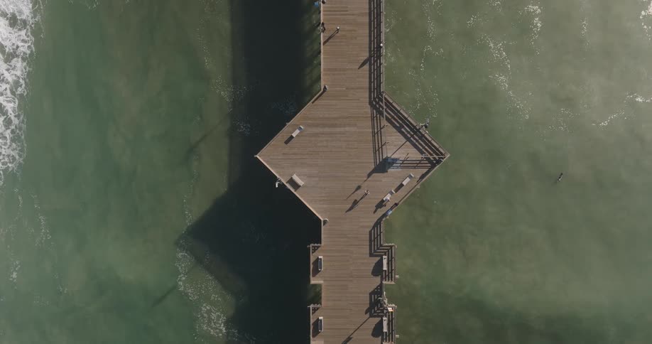 Aerial view of a pier extending over calm waters