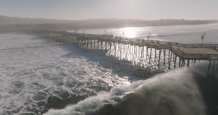 Landscape on a coastline with waves and a jetty