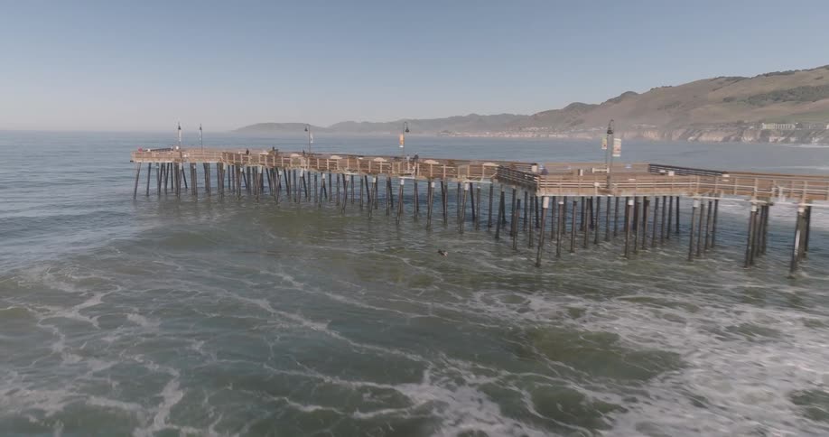 Long wooden pier along the sea on a beach