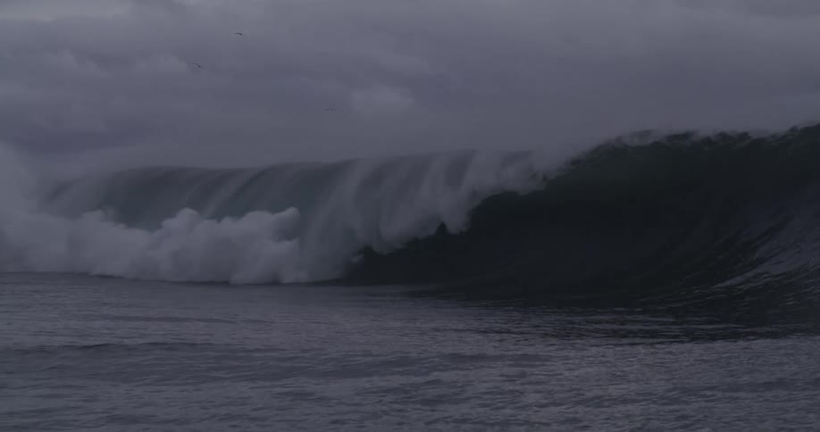A large wave crashes in the ocean