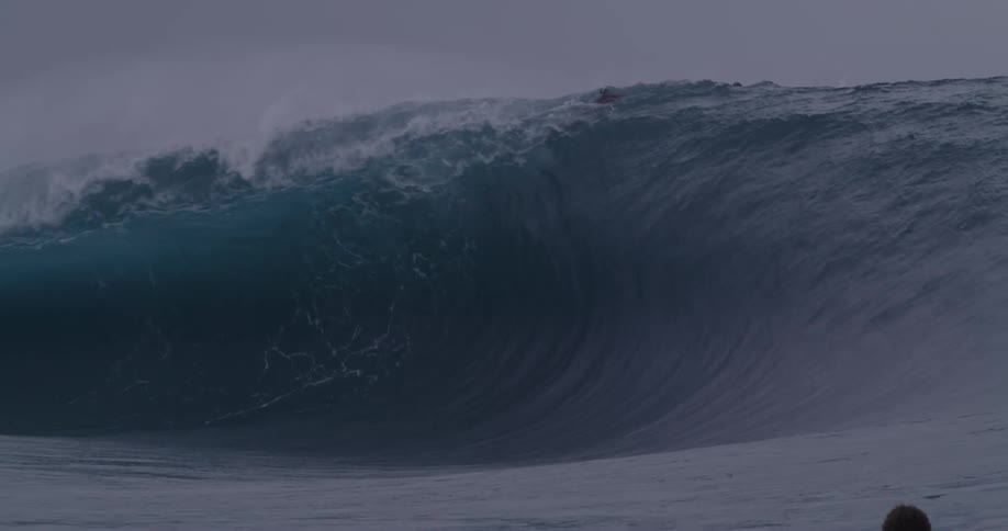 Many surfers are on a large wave