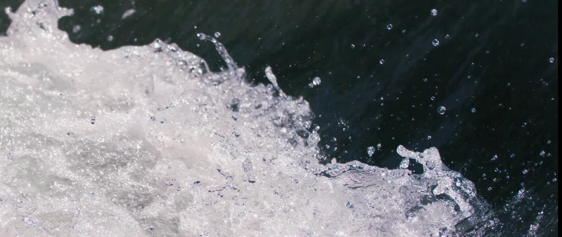 Powerful currents descend with force producing a display of swirling foamy water and scattered drops that create an invigorating spectacle of nature