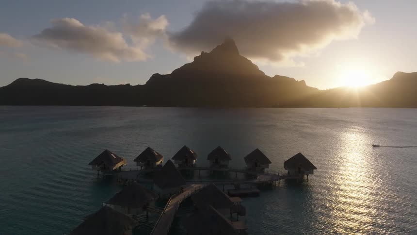 Sun sets behind a mountain