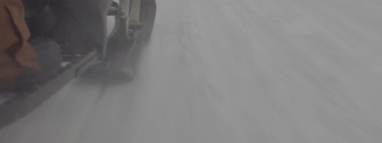 A person is riding a snowmobile in the snow