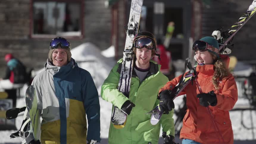 Skiers carry their equipment outside