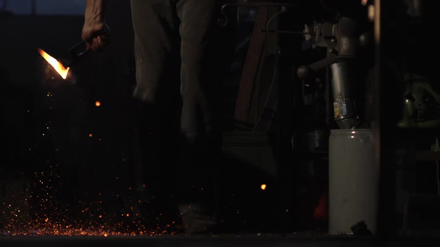 Person holding a hot forging iron