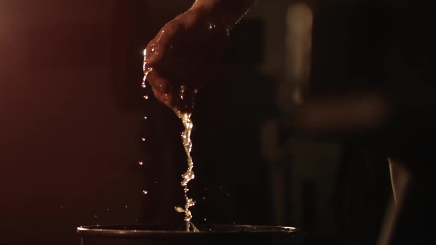 Tattooed mans hand coming out of the water