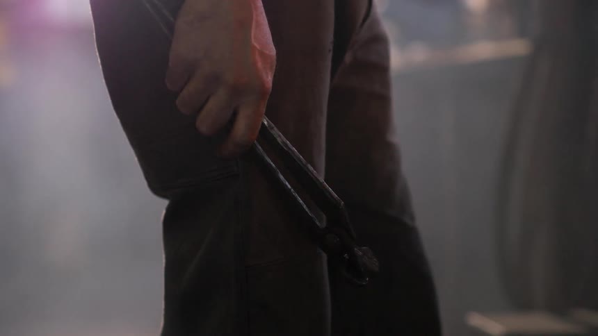 Hand holds a pliers tool