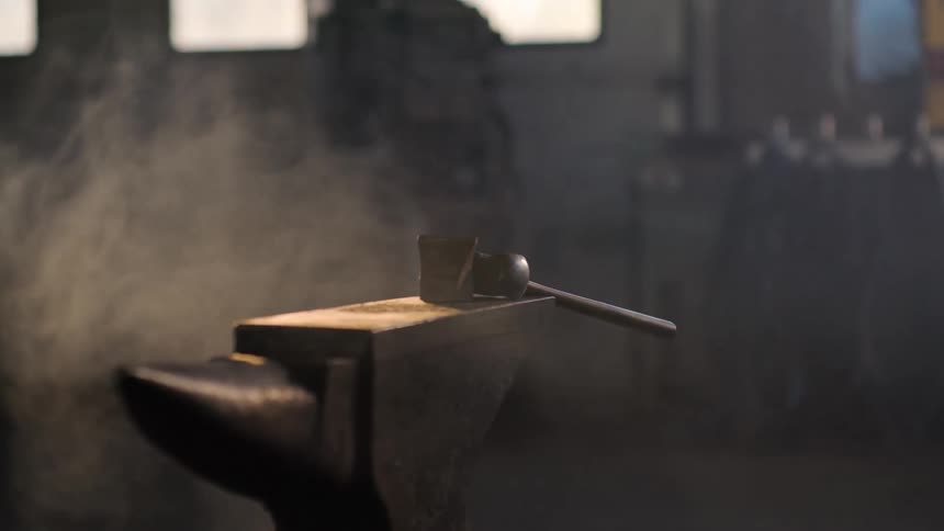 A mallet sits atop an anvil