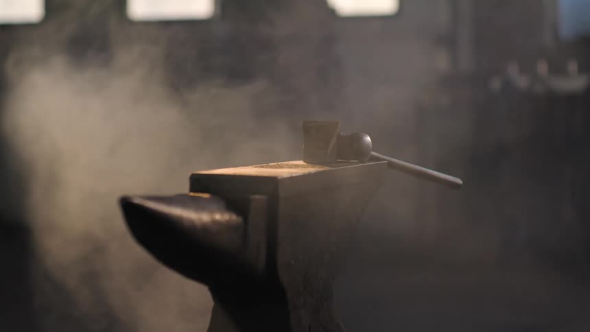 A hammer sits on an anvil