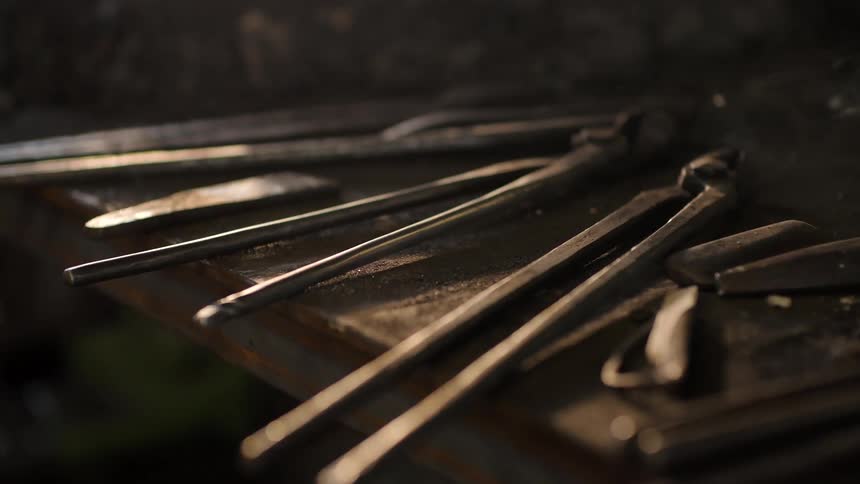 Smoke drifts over a table full of tools