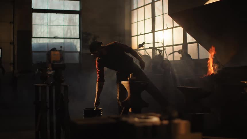 Man working with tools and wetting an iron rod