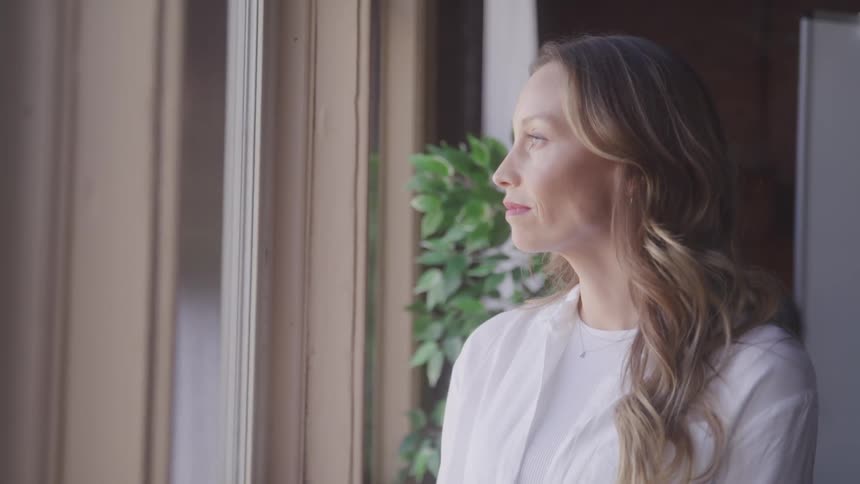 A woman is looking out the window