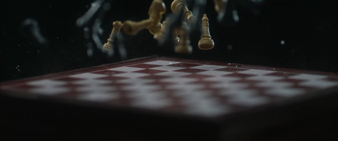 Chess pieces bounce on a chess board in slow motion