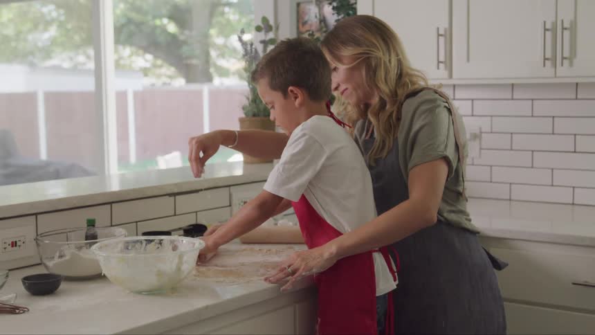 A footage of a mother and son cooking in the kitchen