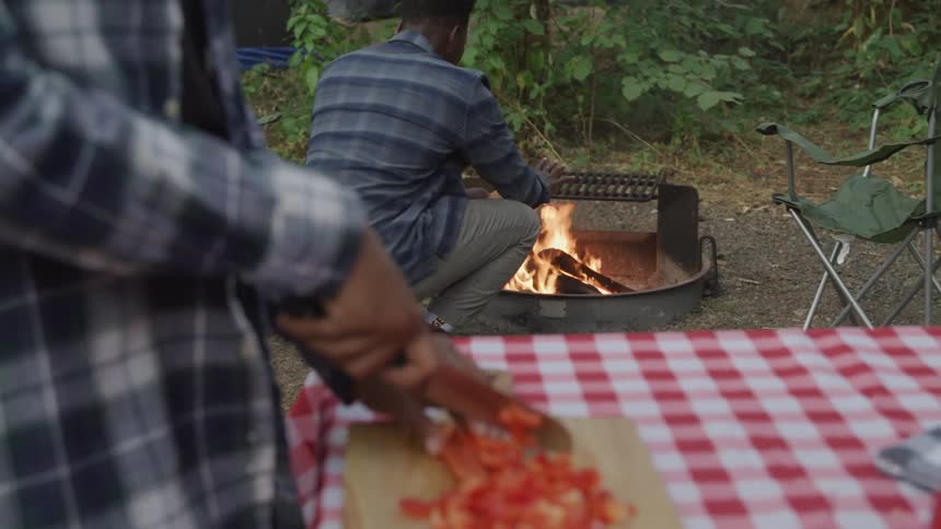 A footage of a person cooking at the camp