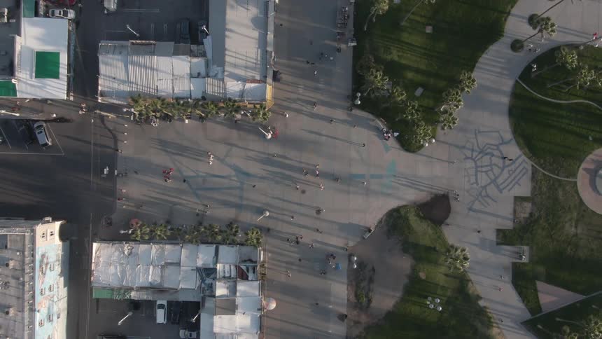 People and vehicles move through the streets of a community