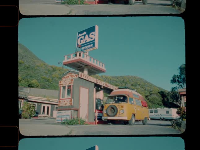 A van pulls up to a gas pump and a man gets out