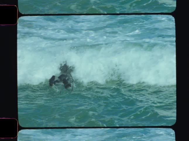 A person in a wetsuit paddles on a surfboard toward an approaching ocean wave