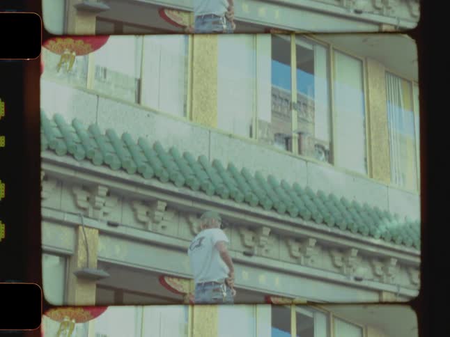 A man is standing on top of his van