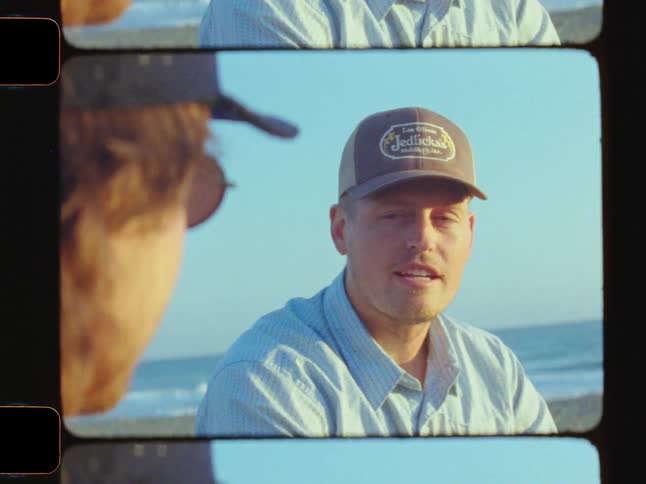 2 boys talking to each other on the beach