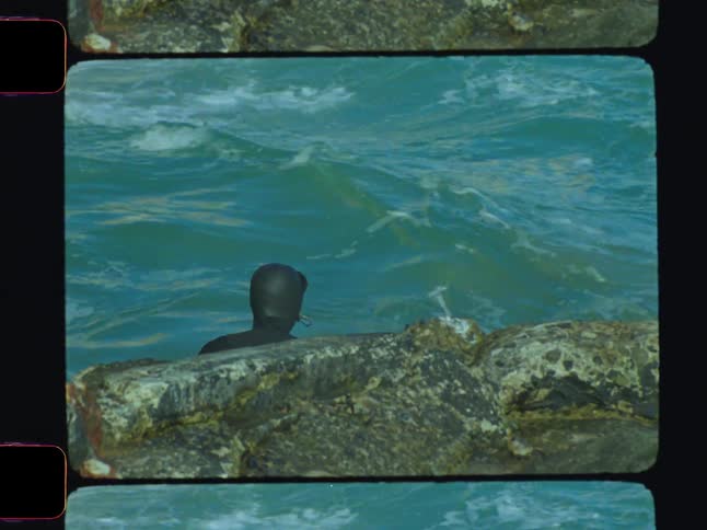 Man in wetsuit in the middle of the sea