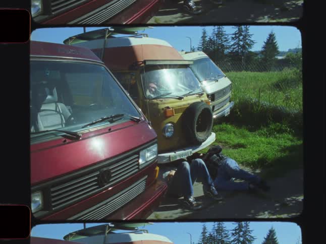 Men are underneath the van repairing it