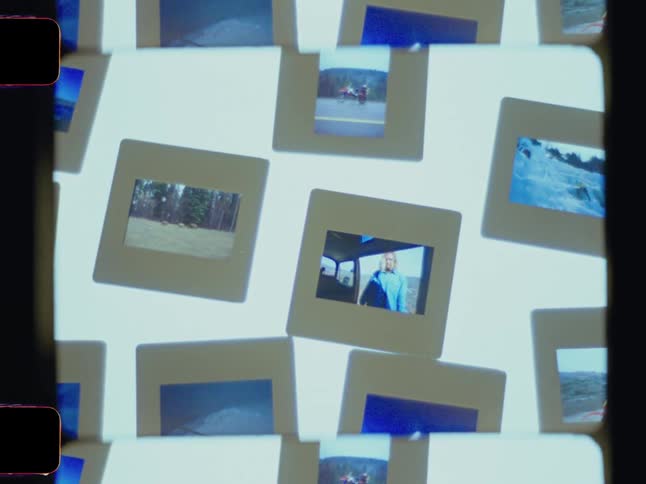 Several photographic slides are scattered displaying scenes like landscapes a person in a blue shirt and outdoor activities