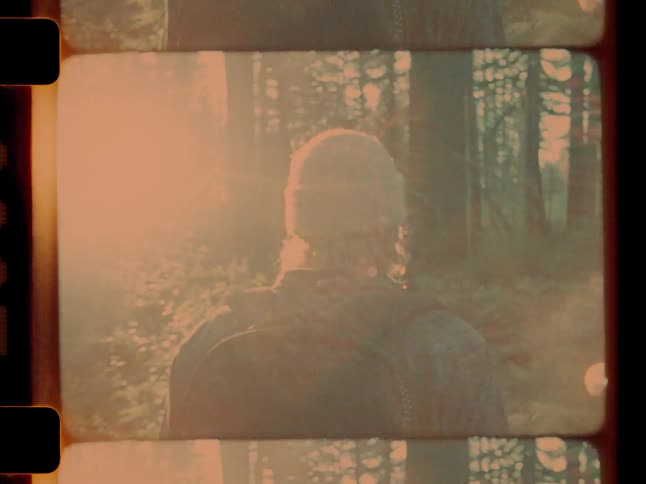 Blonde hiker travels through the woods under a red sky