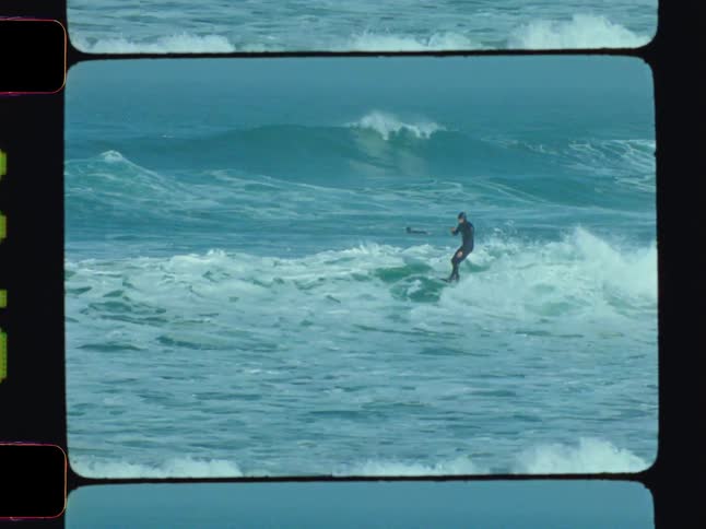 Vintage footage of a surfer surfing small waves