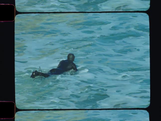 A footage of a diver swimming the waves