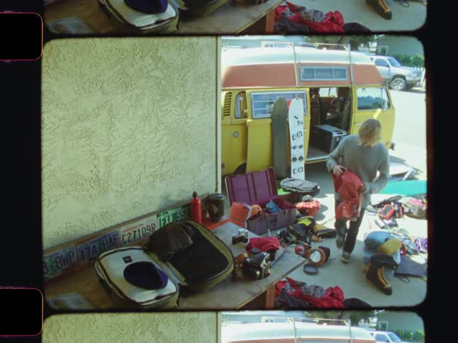 A man is sorting his clothing for a trip