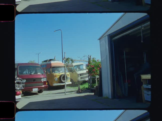 Van parked in a driveway next to a garage