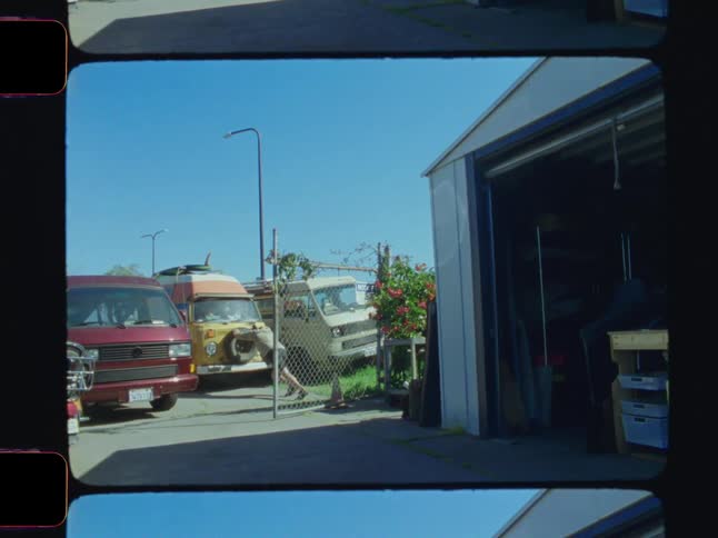 A man pushes his van by the garage