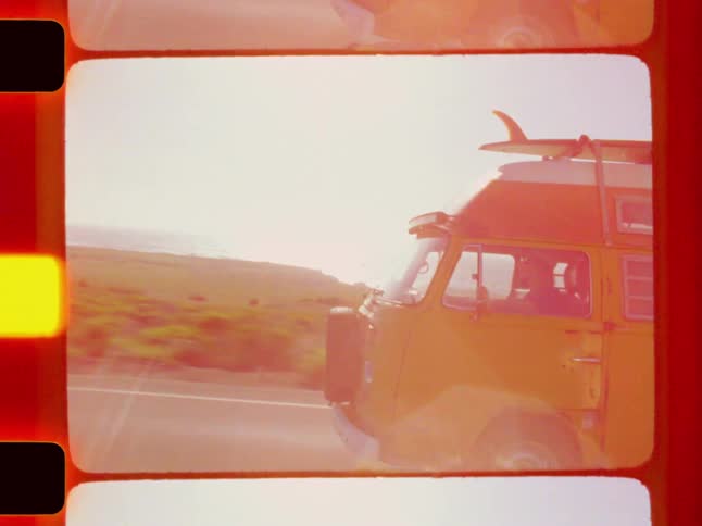 A van is driving on the road by the grass