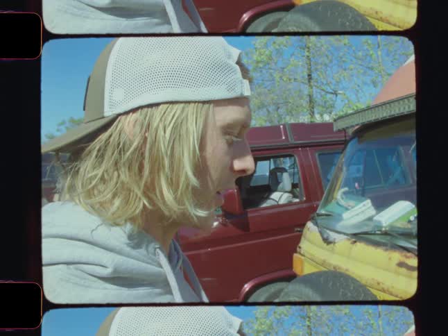 The man is talking and laughing by the van