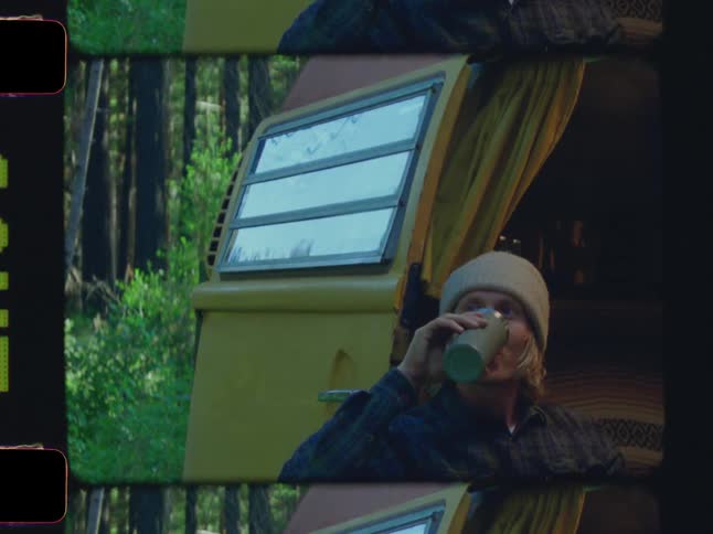 A man takes a drink from his thermos
