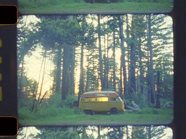 A film footage of a yellow bus in the forest