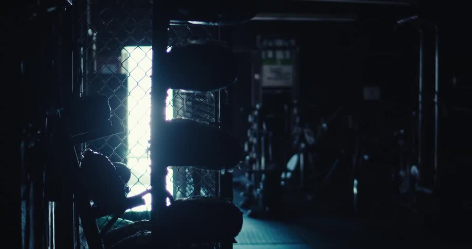The gym is dark and empty